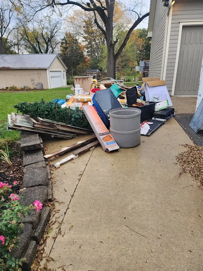 Dumpster being loaded with debris for 12 Yard Dumpster Rental in Jefferson